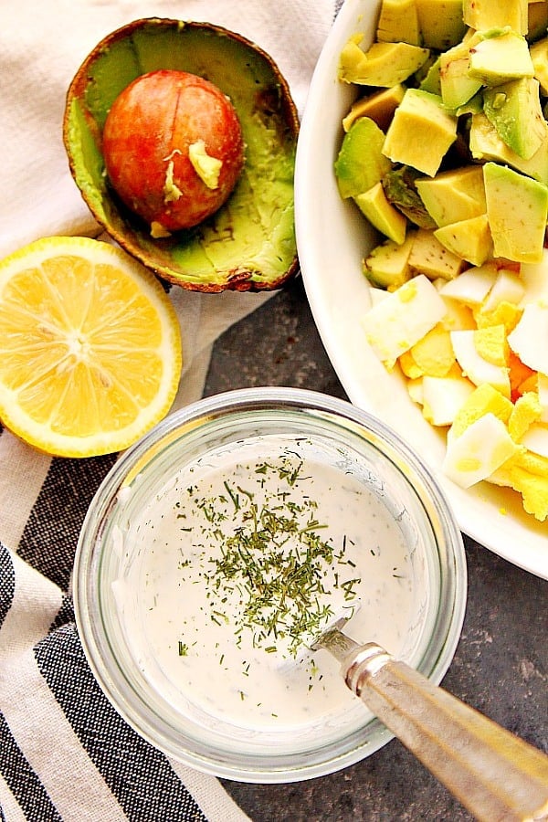 Overhead shot of creamy dressing in glass bowl.