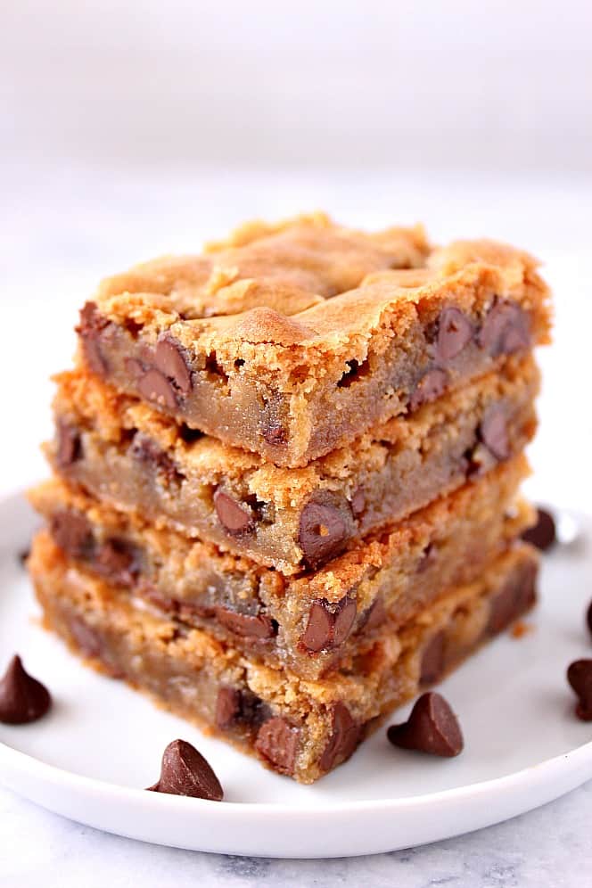 Chocolate Chip Blondies Recipe - buttery cookie bars loaded with chocolate chips. Quick and easy to make, no mixer needed! blondie cookie bars stacked