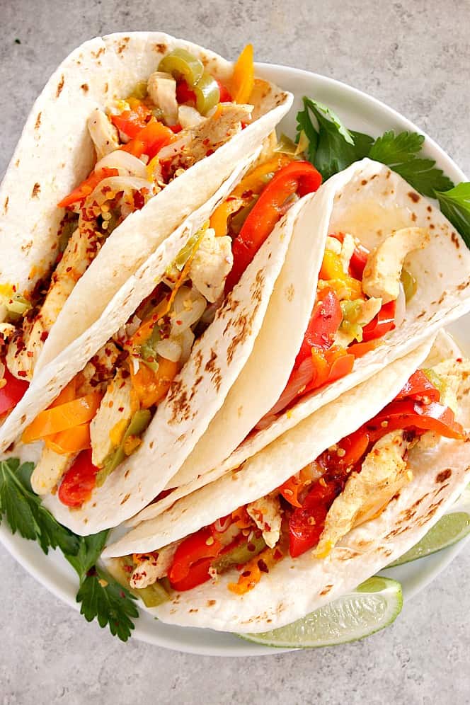 Instant Pot Chicken Fajitas Recipe - quick and easy dinner for the busiest weeknights! Simply add all ingredients to your digital pressure cooker, close lid and press the button. chicken fajitas on plate