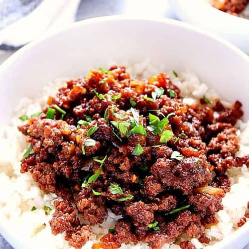 Korean Beef with rice in a white bowl.