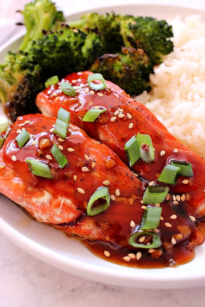 Teriyaki salmon on plate with broccoli and rice.