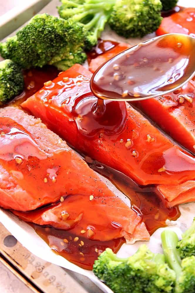 drizzling teriyaki sauce over salmon 