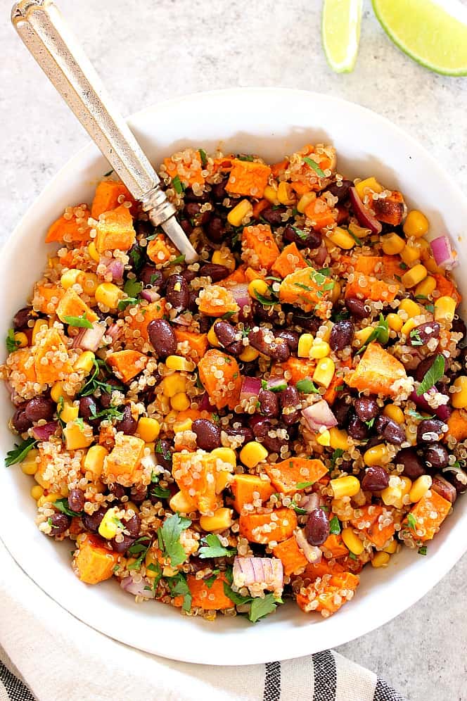 Roasted Sweet Potato Black Bean Quinoa Salad Recipe - healthy and filling quinoa salad with cumin roasted sweet potatoes and quick oil and lime vinaigrette. Perfect as a side dish or a healthy lunch! sweet potato salad in a bowl