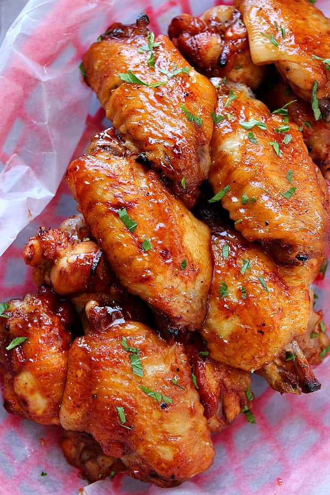 close up of BBQ chicken wings in red basket