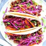Korean tacos on a white plate.