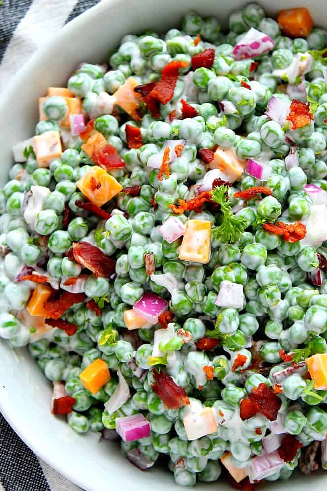 Close up on creamy green pea salad with bacon and cheddar. 