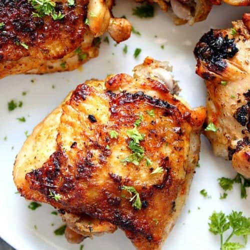 Square image of chicken thighs cooked in the Instant Pot, arranged on a white plate.