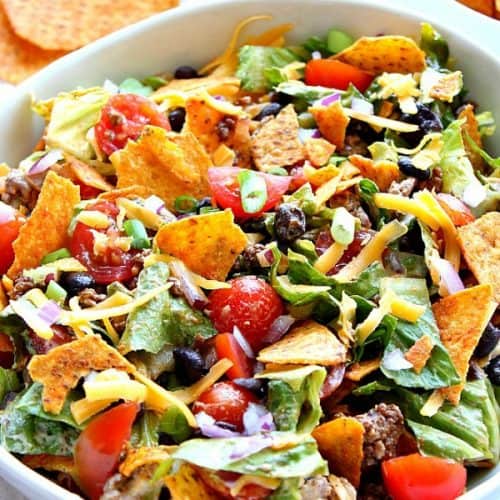 Taco salad in a large white bowl.