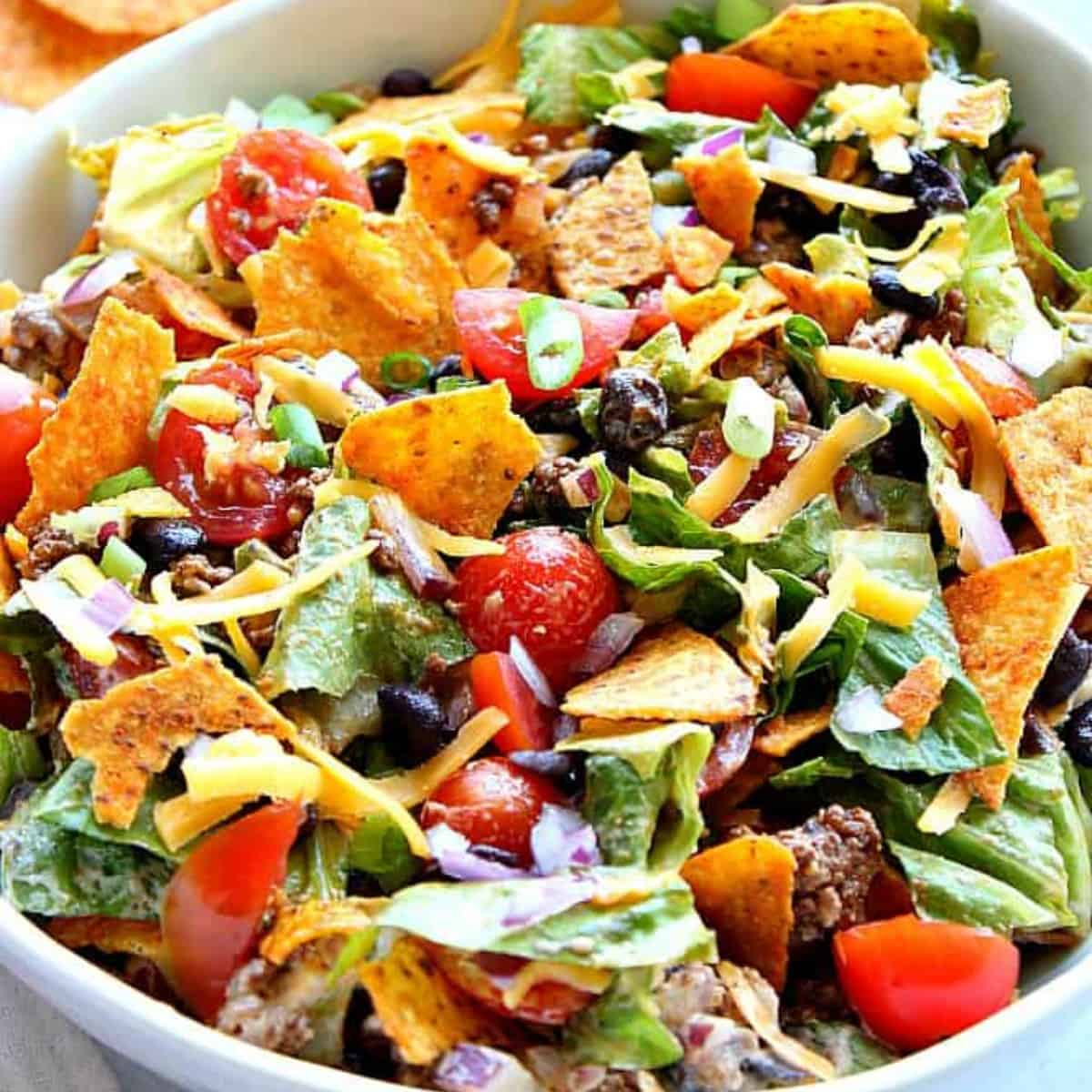 Taco salad with tortilla chips in a bowl.