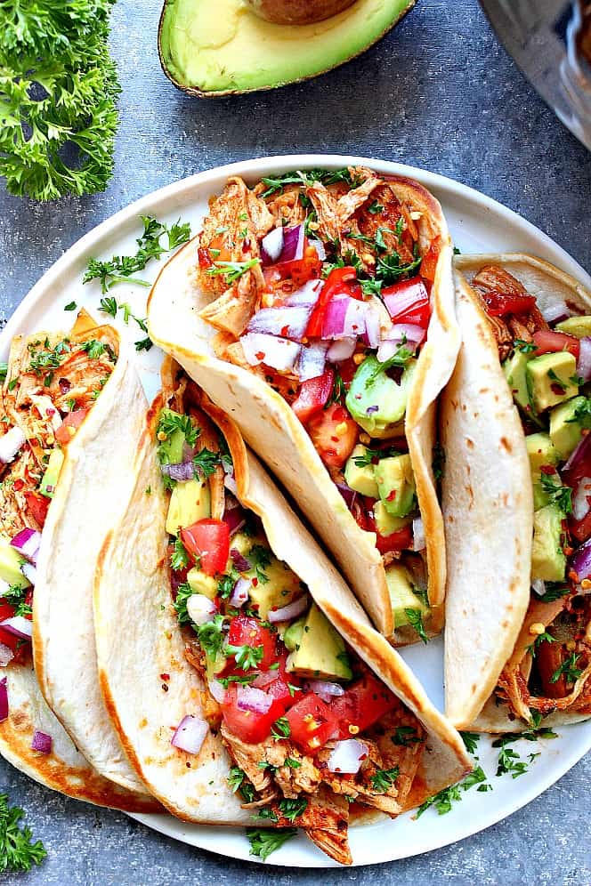 Overhead shot of chicken taco cooked in Instant Pot, served in flour tortillas. 