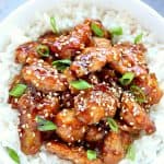Chicken with sesame sauce on rice in a bowl.