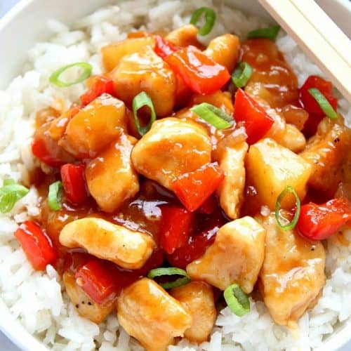 Sweet and Sour Chicken with rice in white bowl.