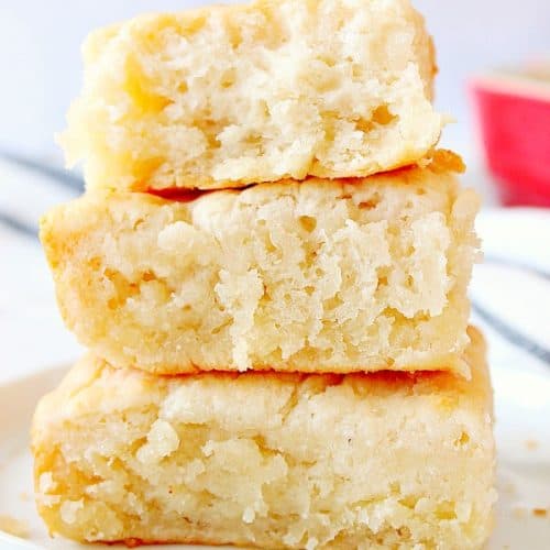 7-UP Biscuits stacked up on white plate.