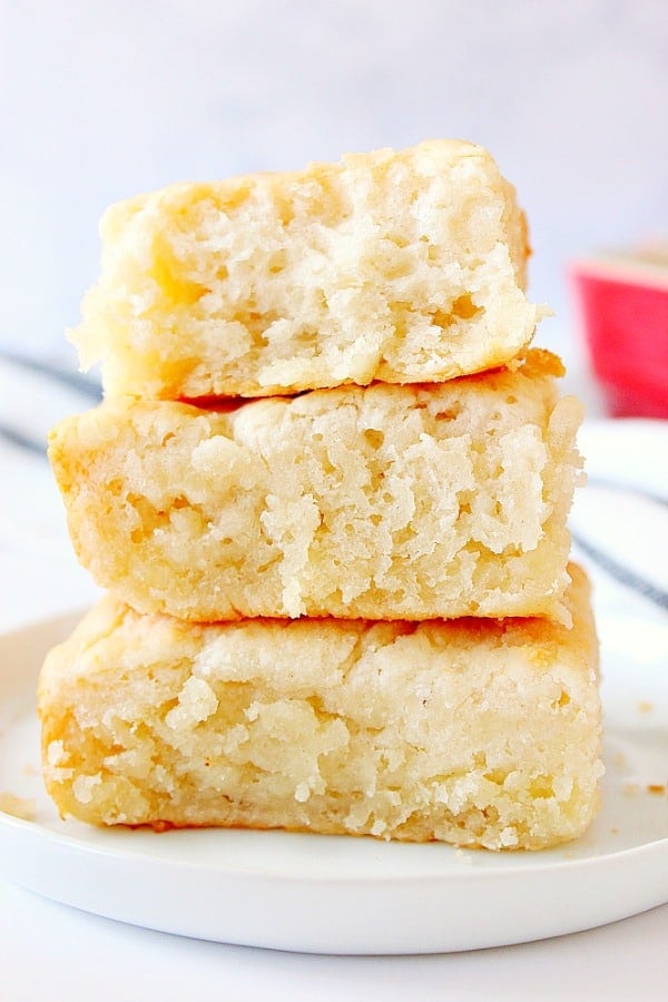 7-UP Biscuits stacked up on white plate.