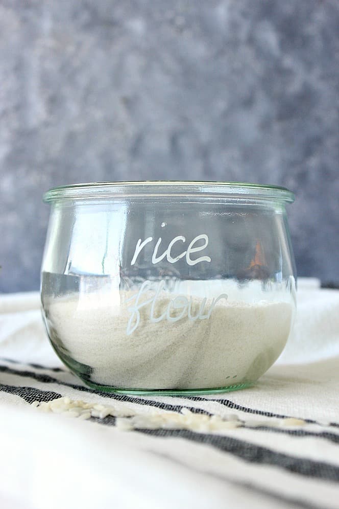 Side shot of rice flour in round glass jar.