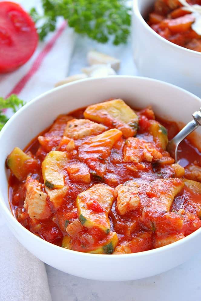 Side shot of Chicken Ratatouille in white serving bowl. 