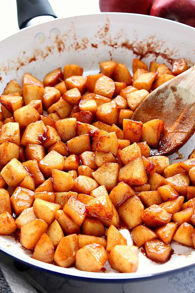 Sauteed apples in white skillet.