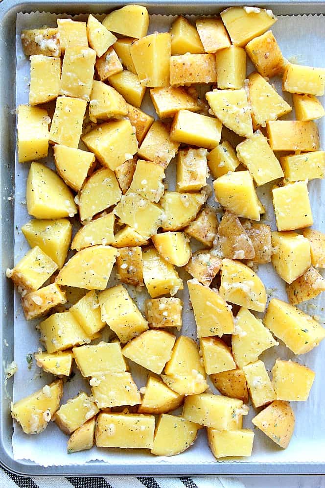 Chopped potatoes in a single layer on baking sheet. 