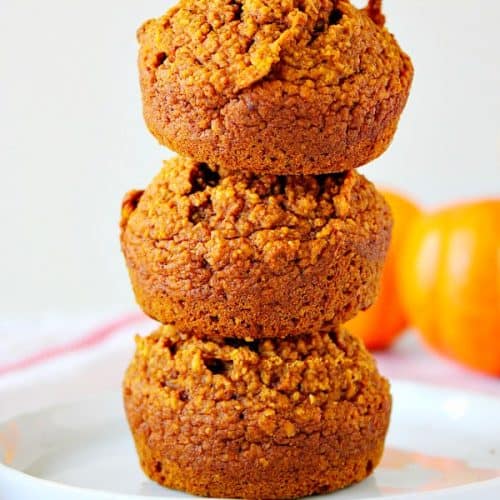 Three Healthy Pumpkin Muffins stacked on each other.