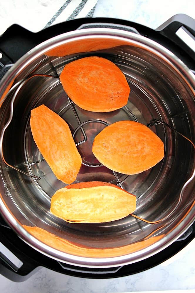 Overhead shot of sweet potato halves on trivet in Instant Pot. 