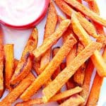 Sweet potato fries on plate with small dish with dip.