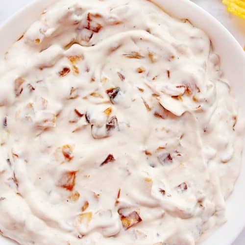 Caramelized onion dip in white bowl.