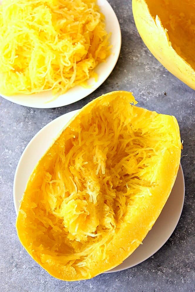 Overhead shot of Instant Pot spaghetti squash half on white plate.