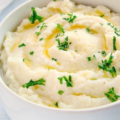 Mashed cauliflower in a white bowl.