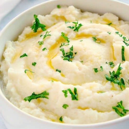 Mashed cauliflower in a white bowl.