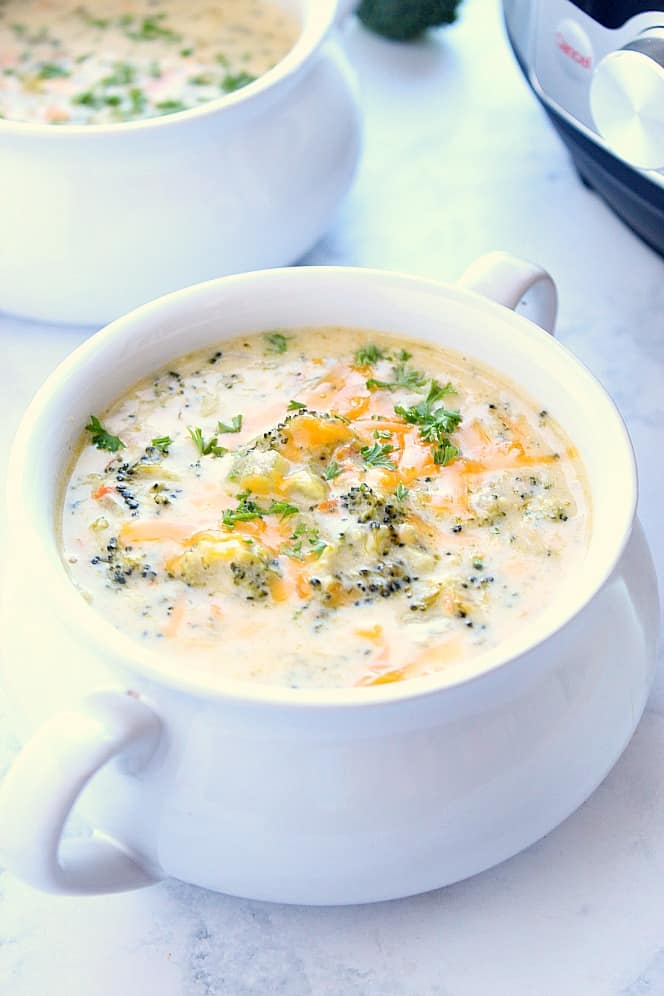 Instant Pot Broccoli Cheddar Soup Recipe - creamy and delicious veggie-packed soup with cheese. Popular restaurant copycat made right in your pressure cooker! #soup #InstantPot Side shot of Instant Pot broccoli cheddar soup in soup bowl with handles.