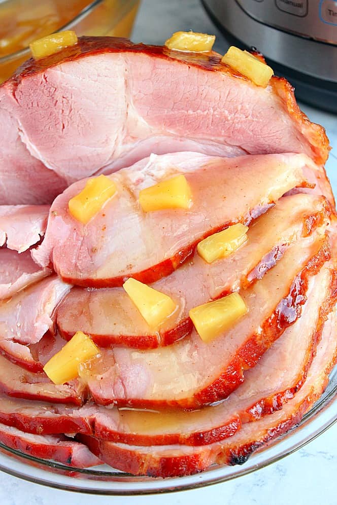 Side shot of sliced ham cooked with pineapple tidbits. 