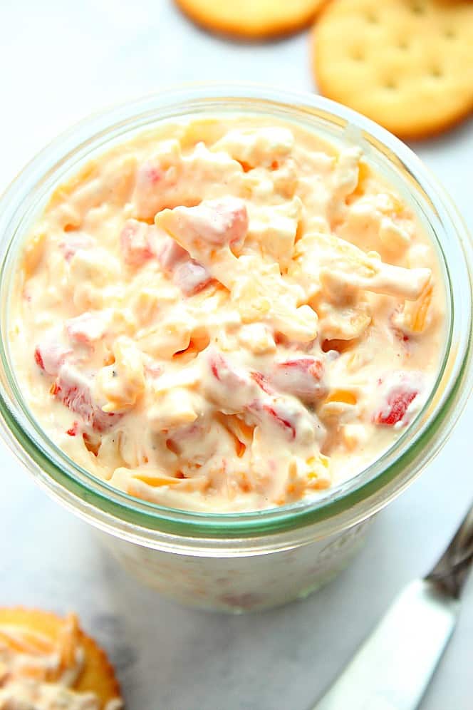 Overhead close up shot of pimento cheese in glass jar. 