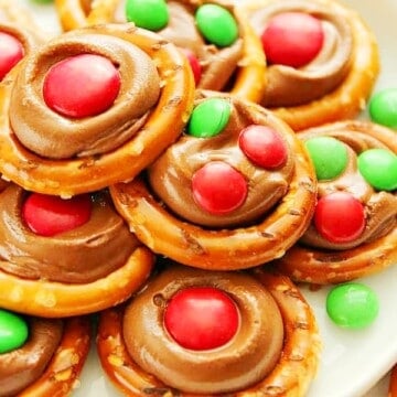 Rolo Pretzel Bites with M&M's candy on a white plate.