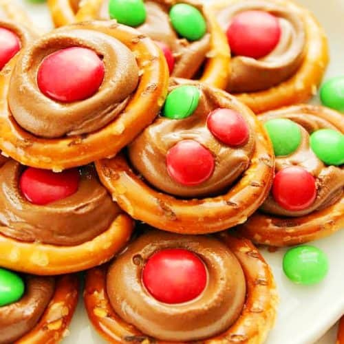 Rolo Pretzel Bites with M&M's candy on a white plate.