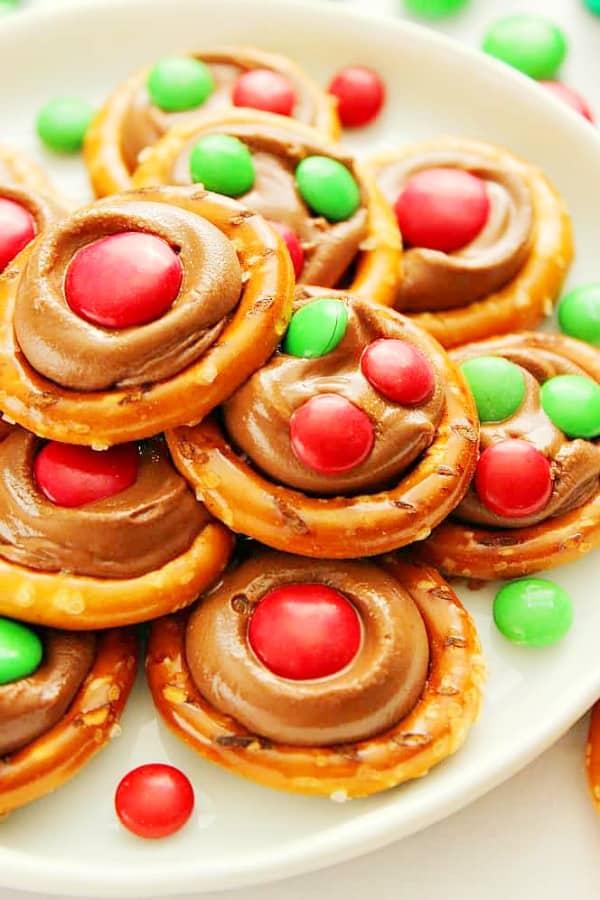 Rolo Pretzel Bites with M&M's candy on a white plate.