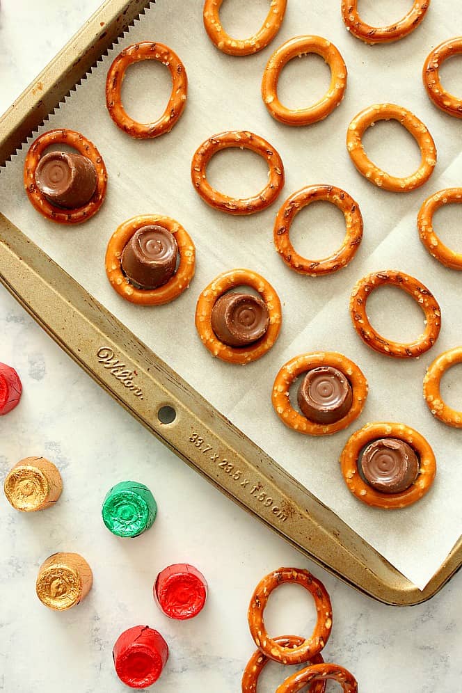 Making Rolo pretzle bites on baking sheet.