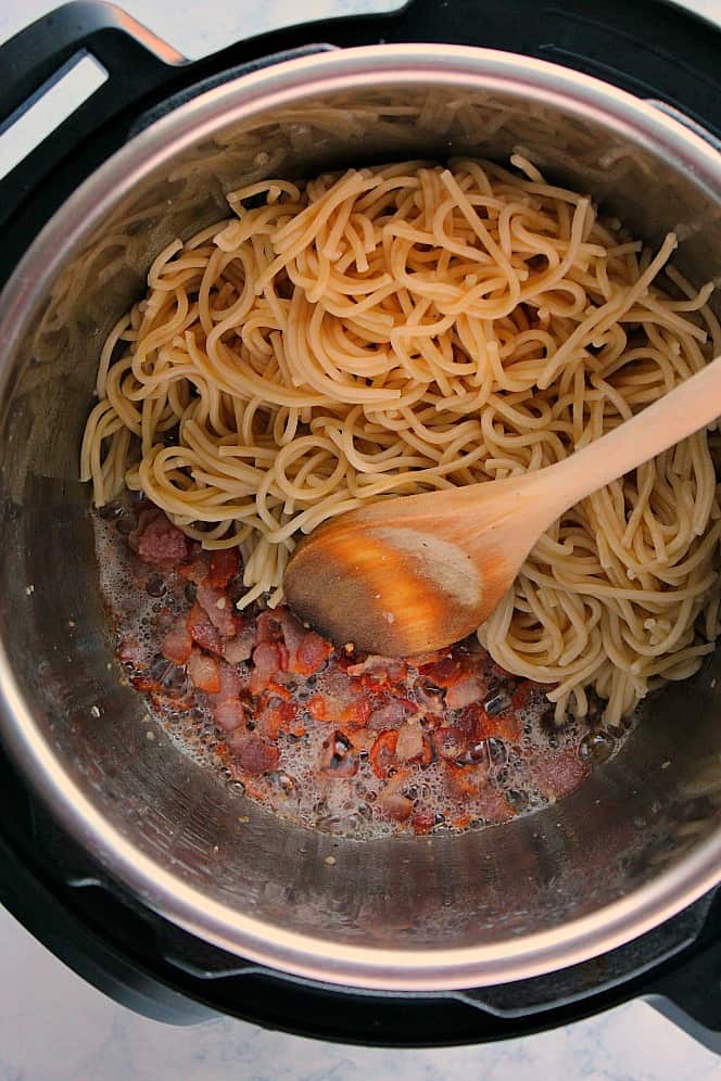 Overhead shot of spaghetti noodles with bacon in the Instant Pot.