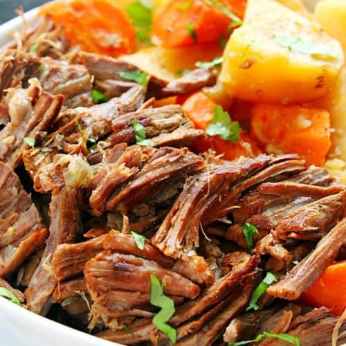 Pot roast with potatoes and carrots on a plate.