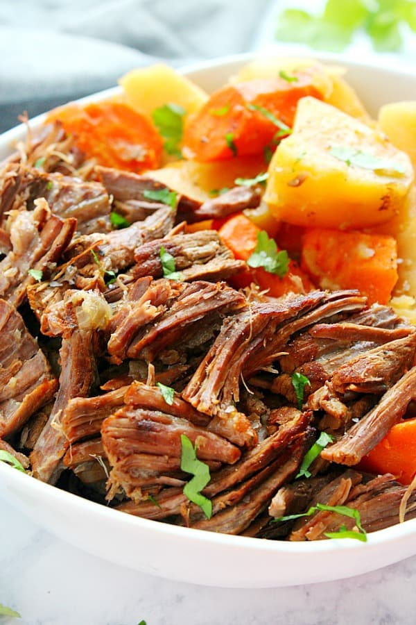 Pot roast with potatoes and carrots on a plate.