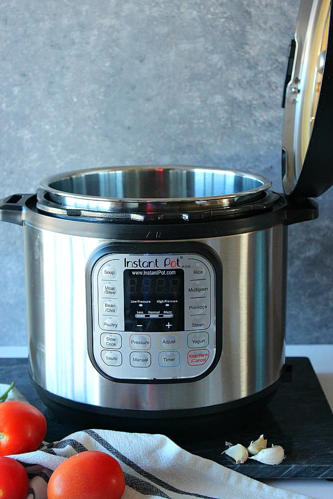 Open Instant Pot with lid in the handle.
