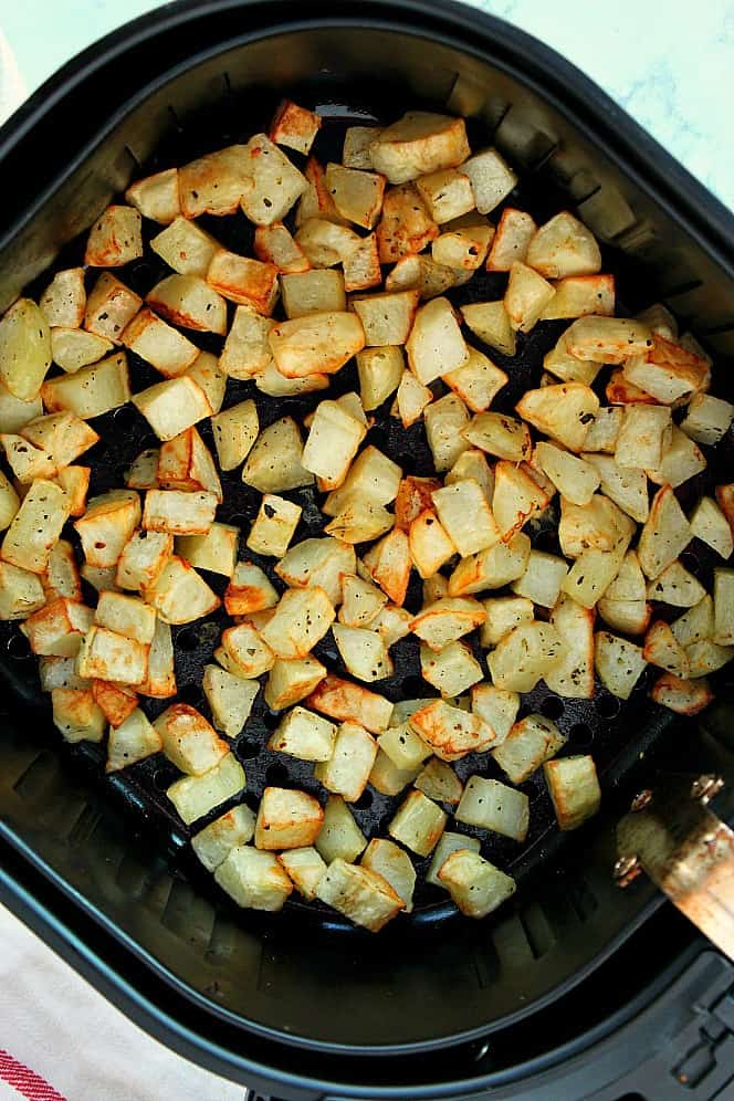 Overhead shot of roasted and done potatoes in the air fryer basket.