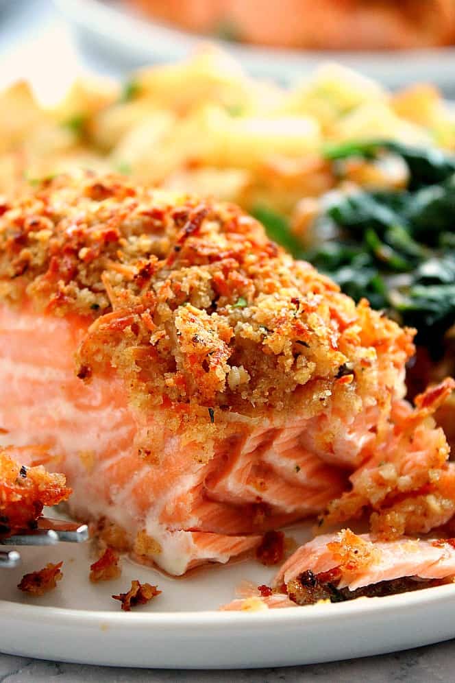 Parmesan Crusted Salmon on plate with potatoes and spinach.