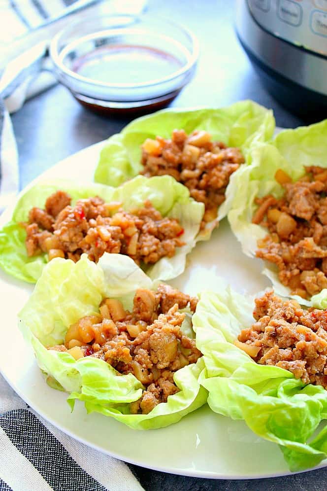 Instant Pot Chicken Lettuce Wraps on white plate.