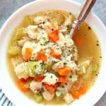 Instant Pot Chicken and Rice soup in white bowl with spoon.