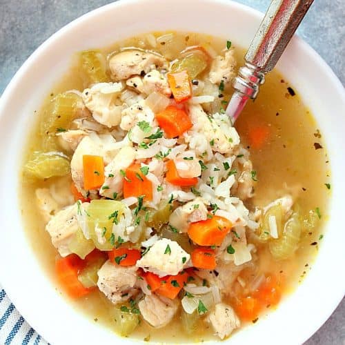 Instant Pot Chicken and Rice soup in white bowl with spoon.