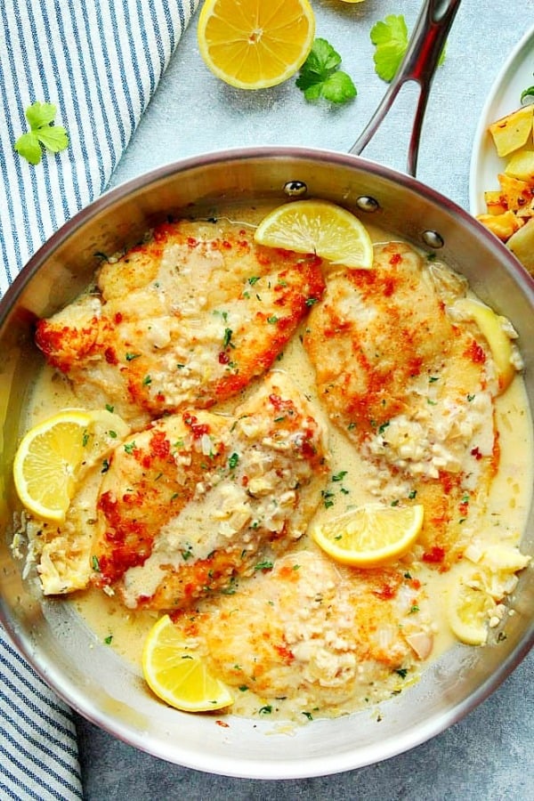 Creamy Lemon Garlic Chicken - quick seared chicken with creamy and buttery lemon garlic sauce! Creamy Lemon Garlic Chicken in a stainless steel skillet.