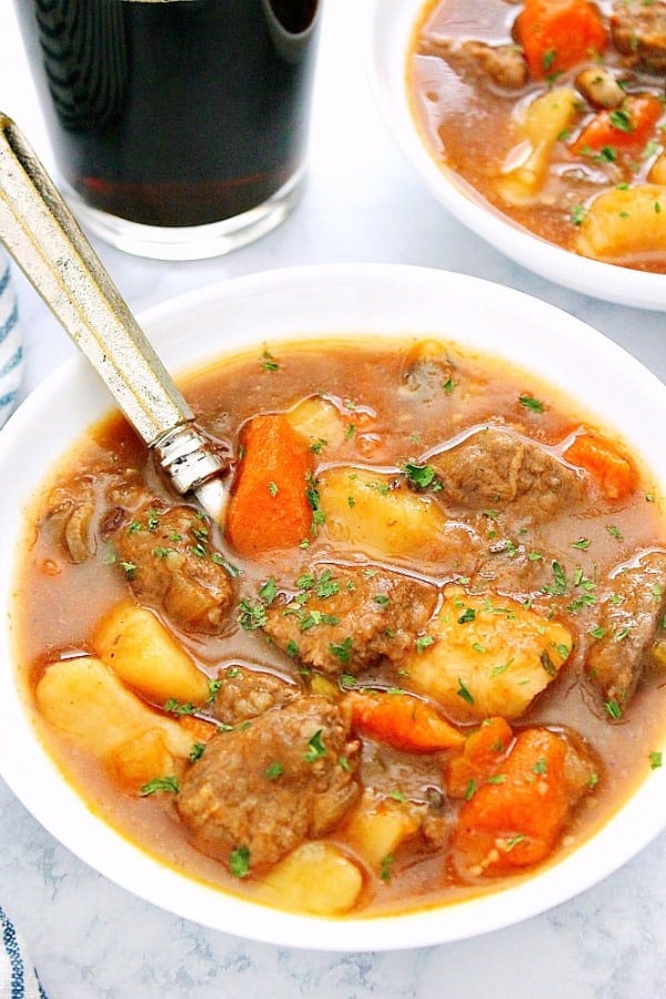 Instant Pot Beef Stew in a white bowl with spoon.