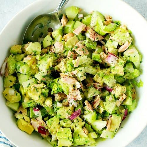 Tuna salad with avocado in a large white bowl.