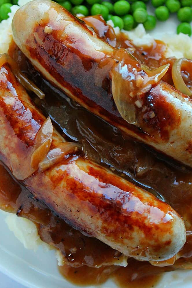 Close up shot of bangers and mash with onion gravy.