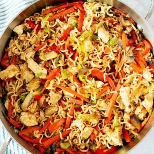 Chicken Yakisoba with vegetables in a skillet.